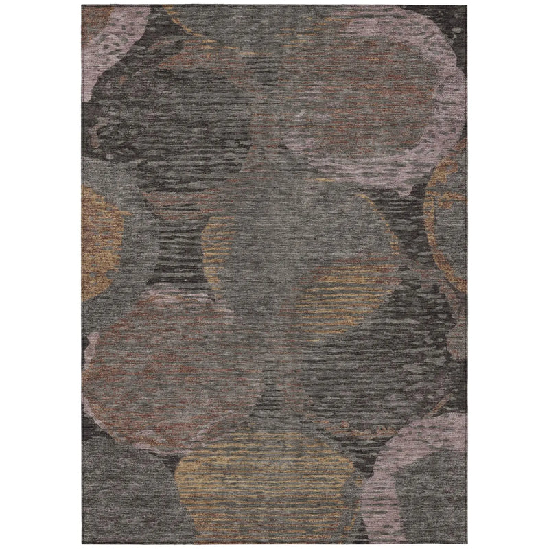 Multicolor abstract area rug in grey, pink, and gold hues, featuring circular patterns and a textured surface.