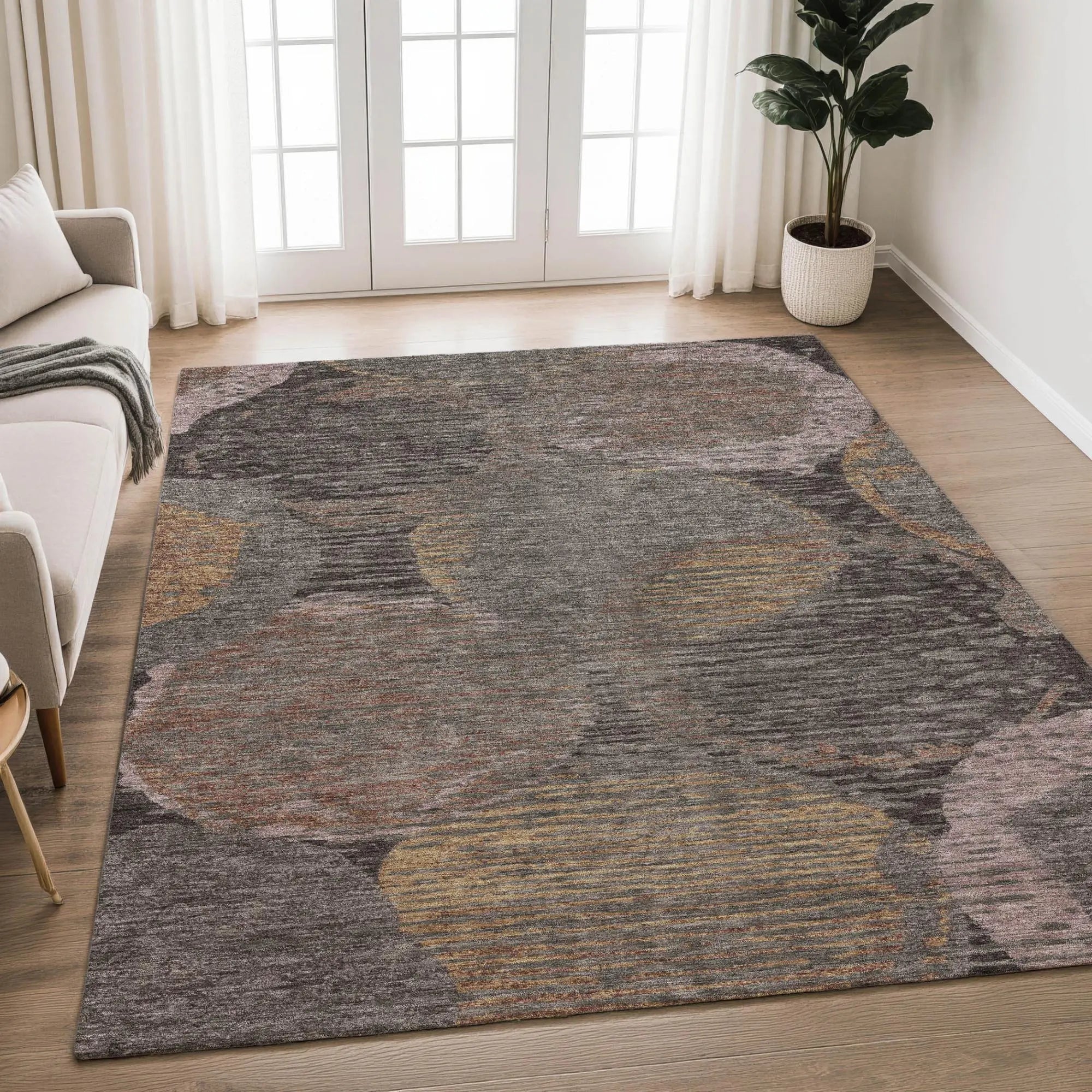 Gray area rug with abstract multi-colored circles in warm tones, ideal for modern home decor. Soft synthetic material.