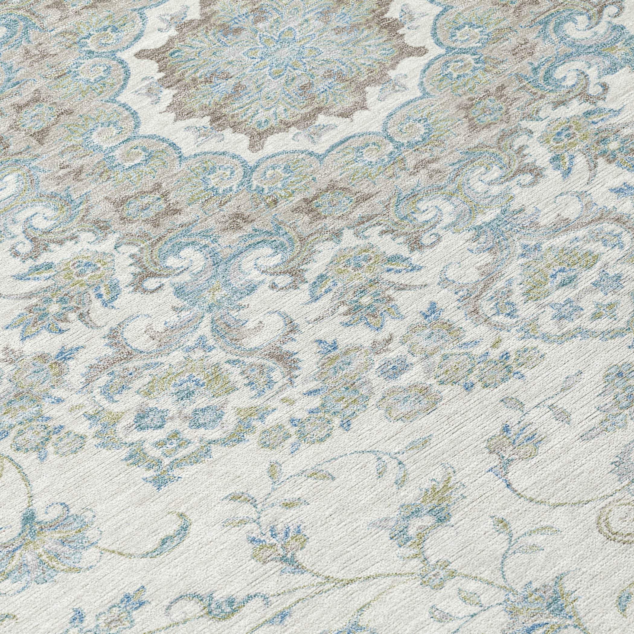 Light blue and beige ornate area rug with a floral design, featuring intricate patterns on a soft, textured background.