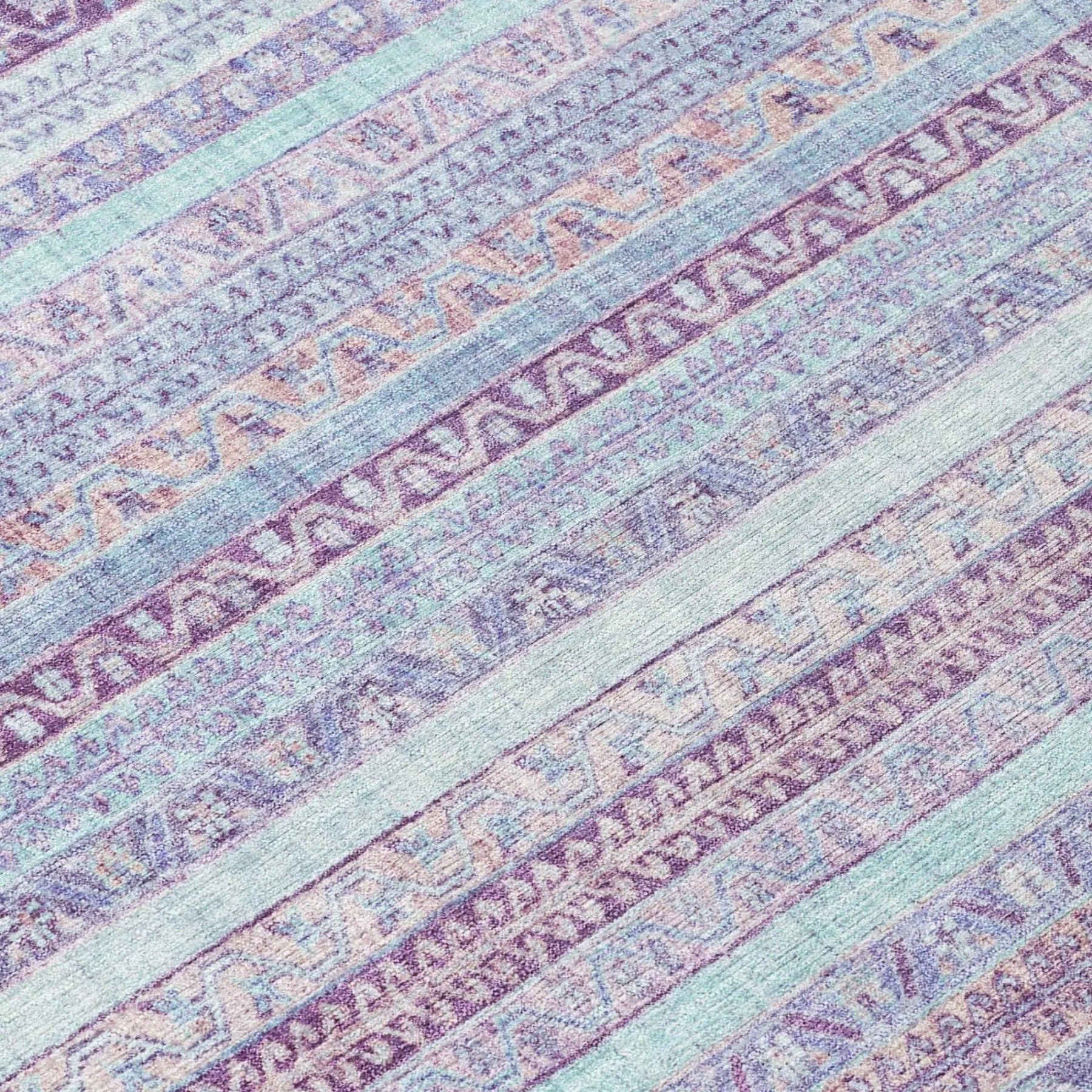 Multicolored purple and pastel area rug with geometric patterns, crafted from soft, durable fibers. Perfect for modern decor.