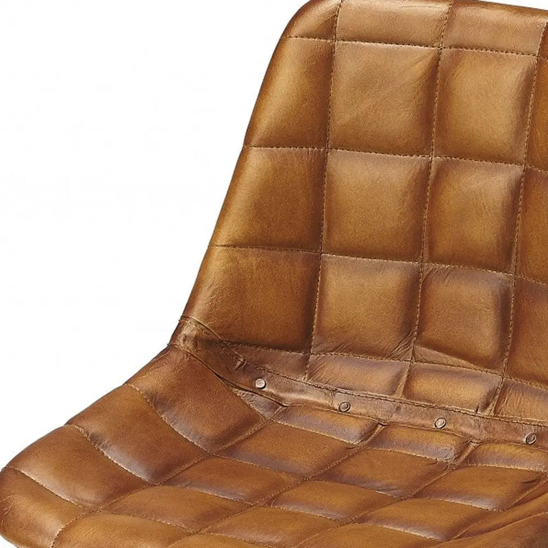 Brown leather quilted chair seat with button detailing, perfect for modern and vintage decor styles.
