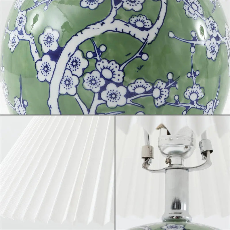 Green ceramic lamp with blue floral design and white pleated shade, elegant accent for modern decor.