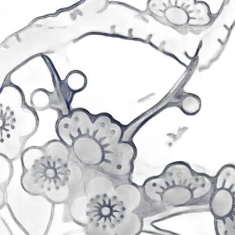 Delicate white floral lace fabric with intricate black designs, perfect for elegant dressmaking or crafting projects.