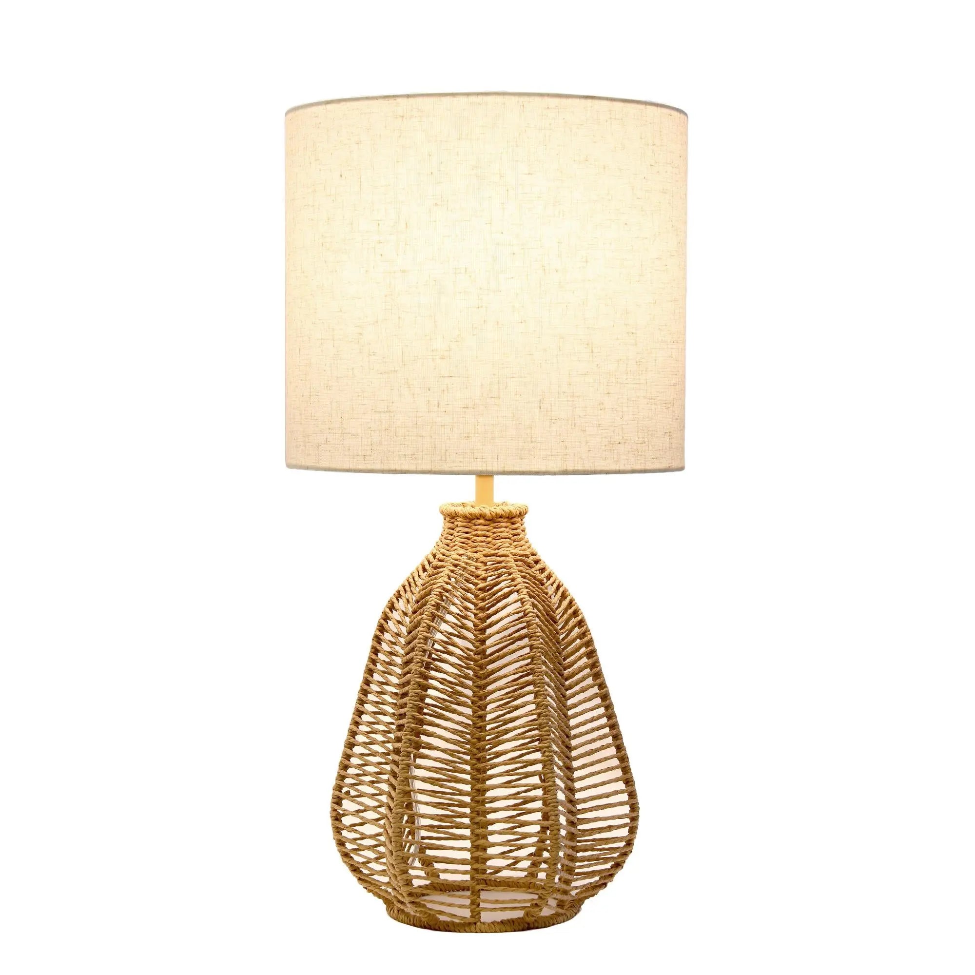 Natural woven rattan table lamp with a cream linen drum shade, perfect for a boho-chic home decor.