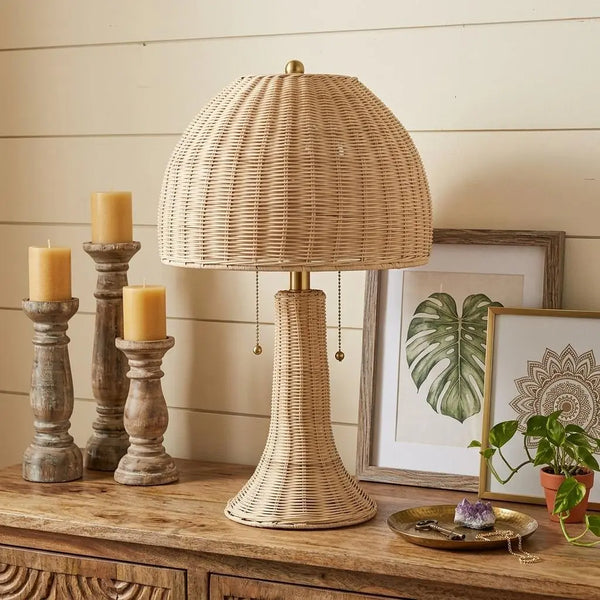 Natural rattan table lamp with a dome shade, brass accents, and a stylish, boho design for cozy home decor.
