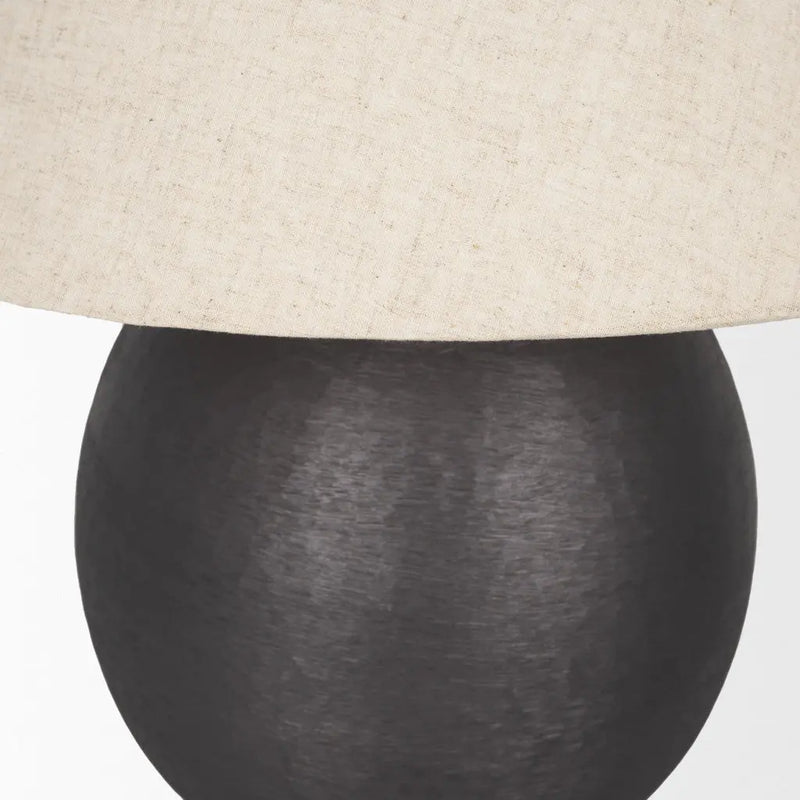 Black textured ceramic lamp with a beige linen shade, perfect for modern and minimalist decor.