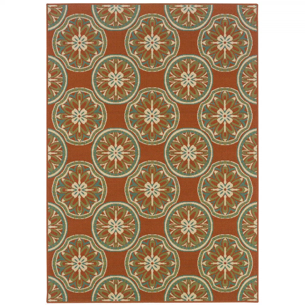 Terracotta outdoor rug with floral medallion pattern, durable polypropylene material, perfect for patios and gardens.