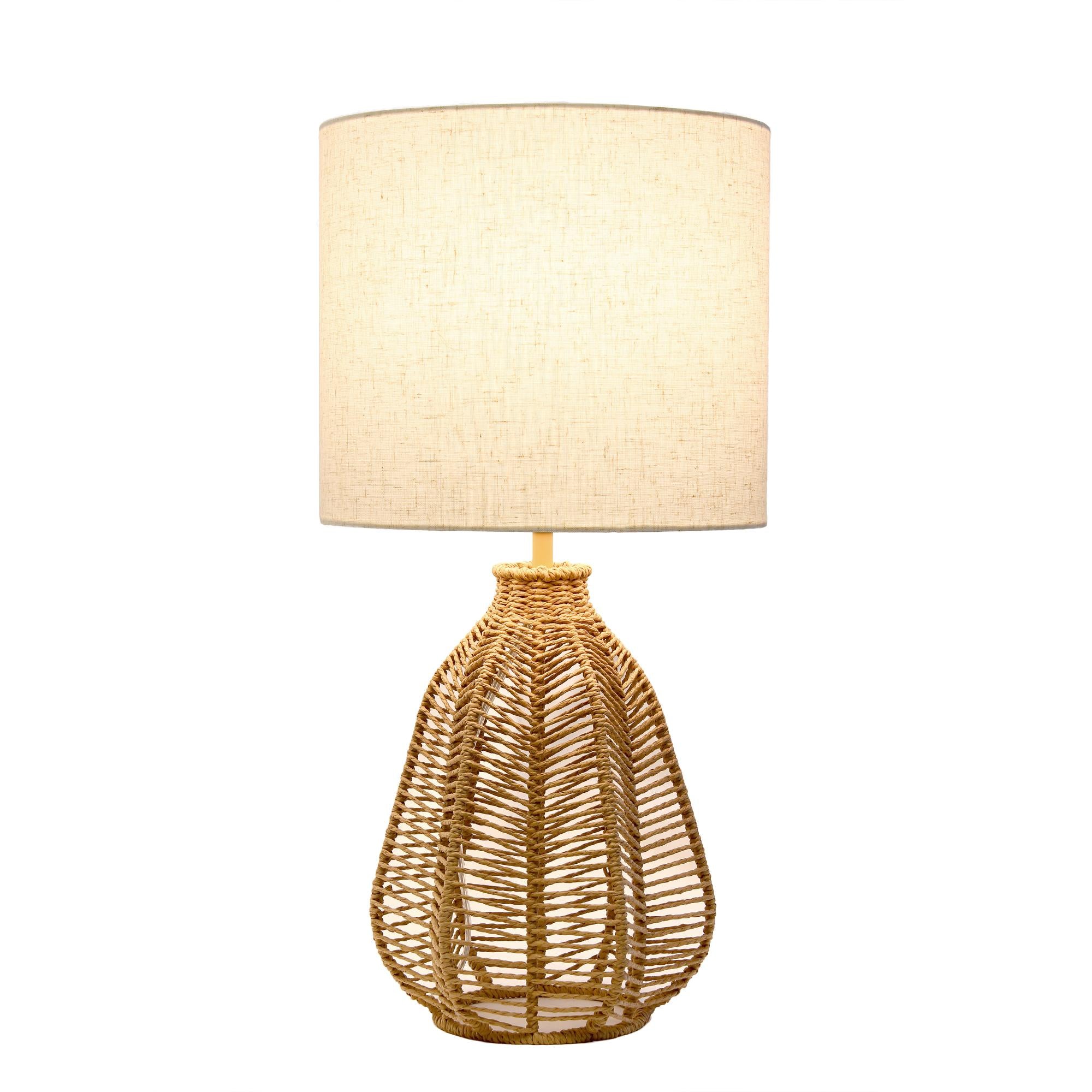 Natural woven rattan table lamp with a cream linen drum shade, perfect for a boho-chic home decor.