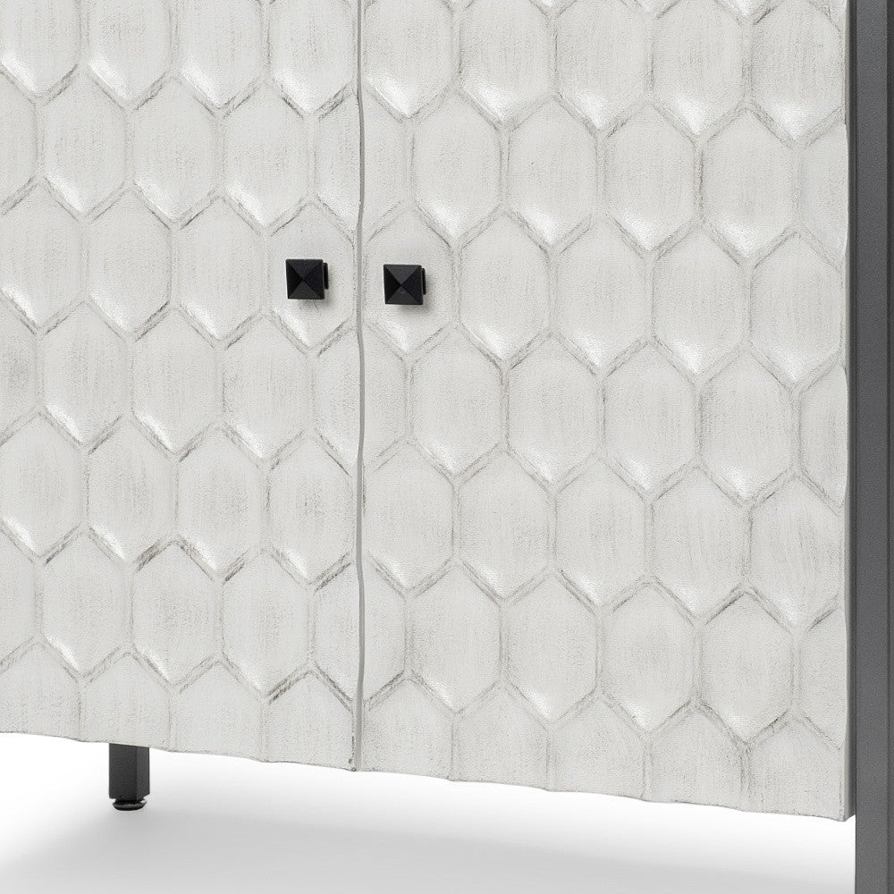 White honeycomb-patterned cabinet with black cube handles and a sleek metal frame. Perfect for modern decor.