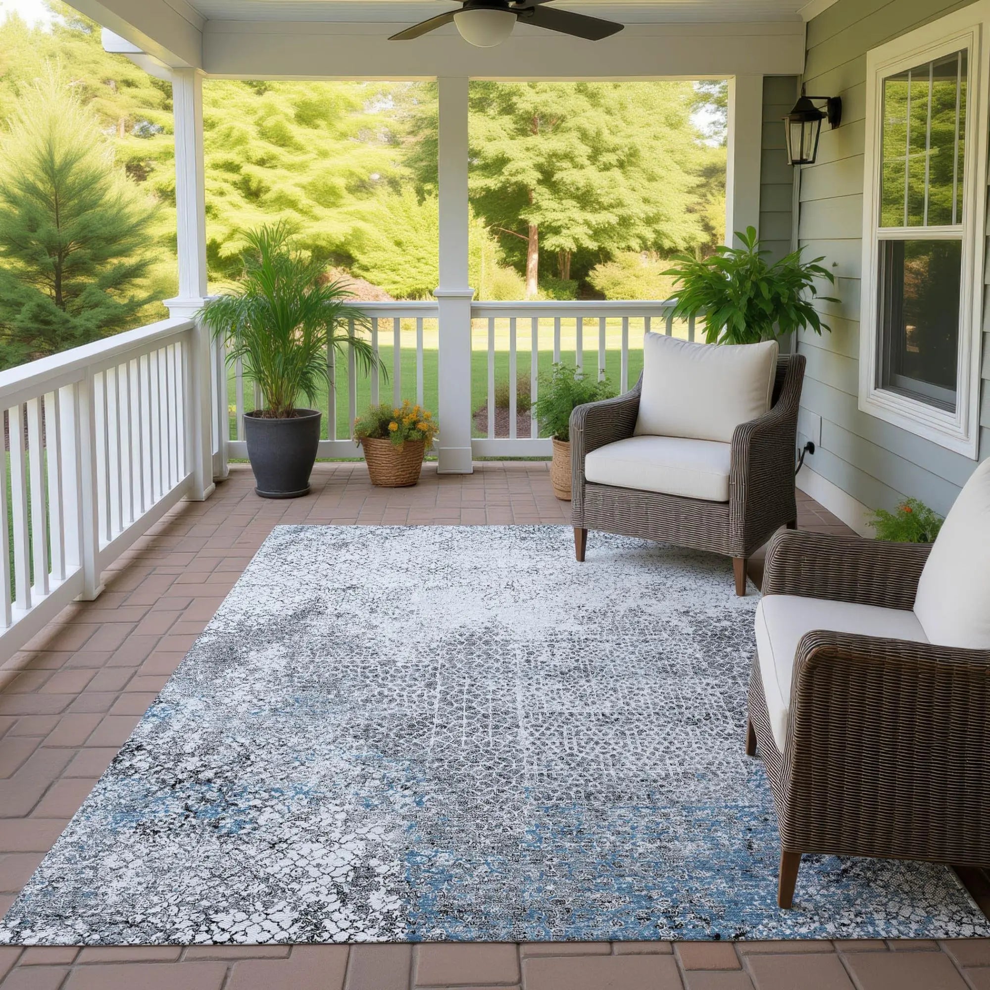 Gray and blue indoor/outdoor area rug with a modern abstract design, perfect for patios or porches.