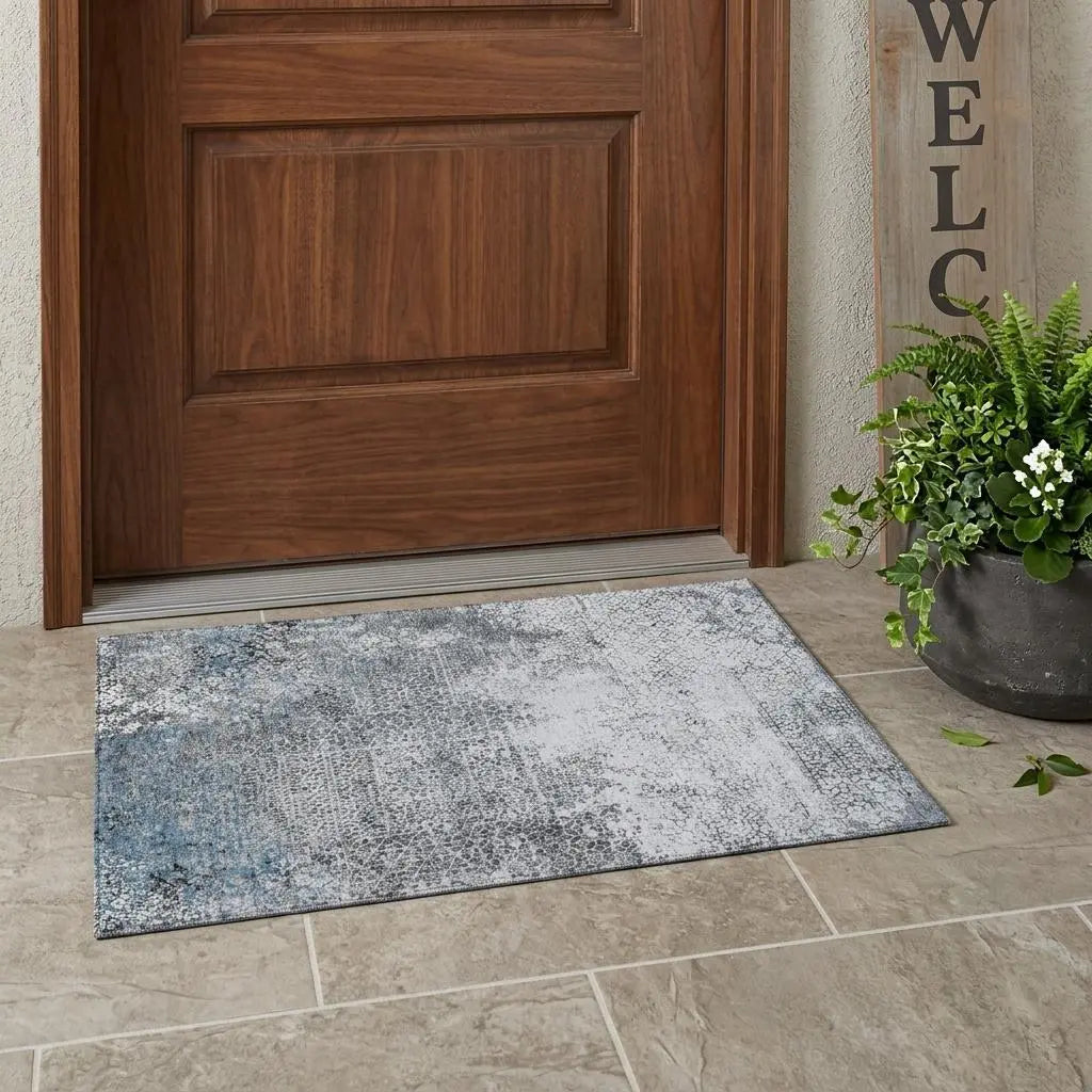 Gray and blue abstract patterned indoor/outdoor mat, durable fabric, perfect for entryways or patios.