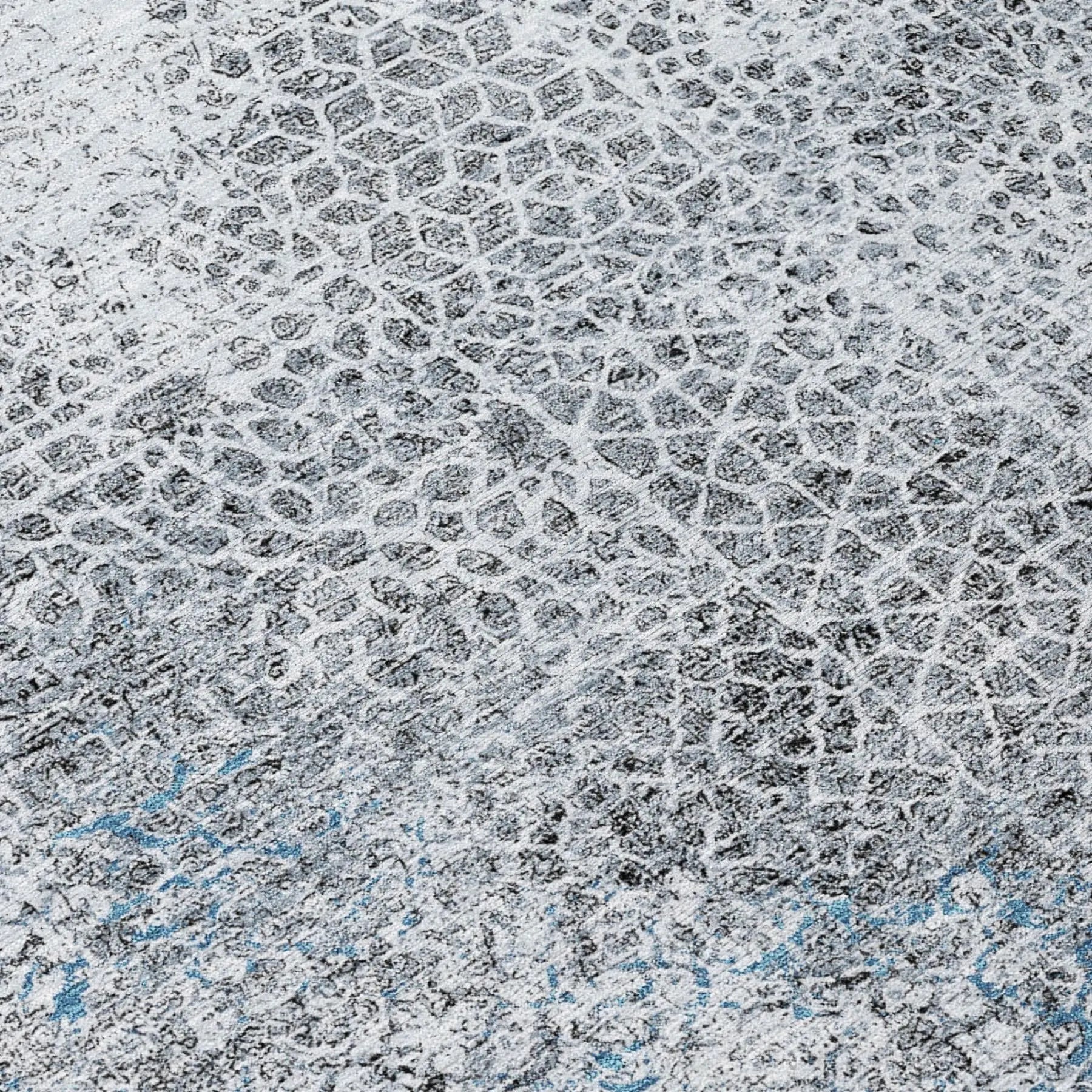 Abstract gray and blue textured area rug in modern style, featuring a contemporary honeycomb pattern.