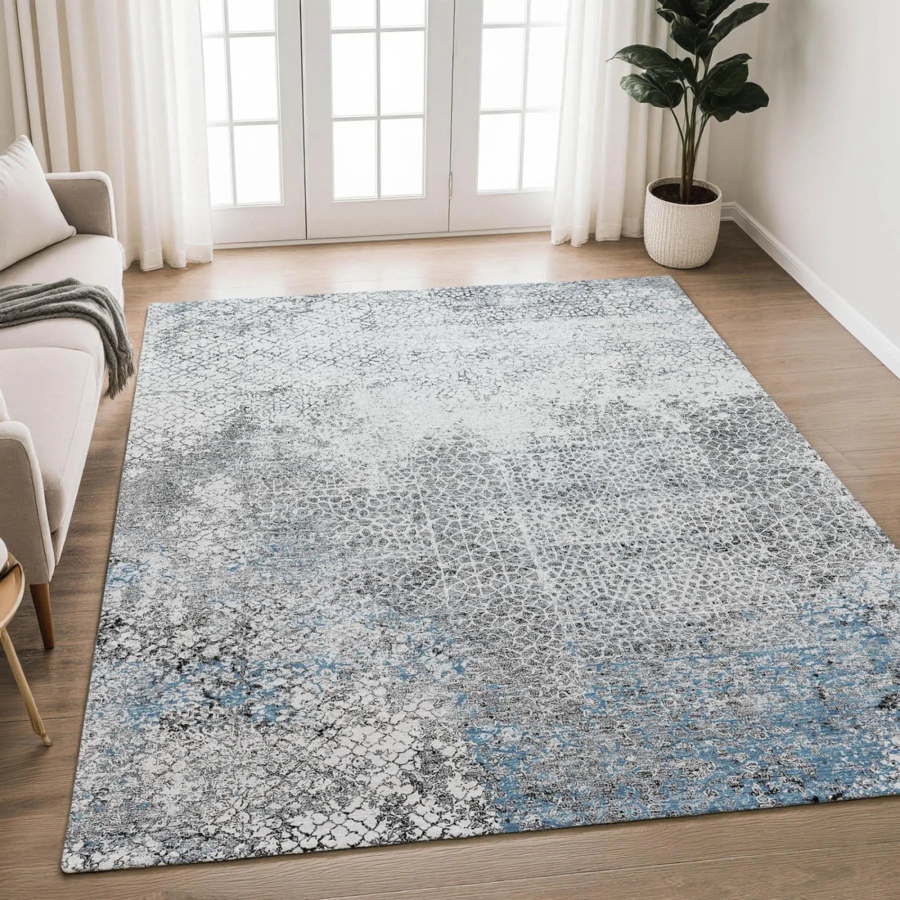 Gray and blue abstract area rug, soft polyester fabric, versatile modern design, perfect for living rooms.
