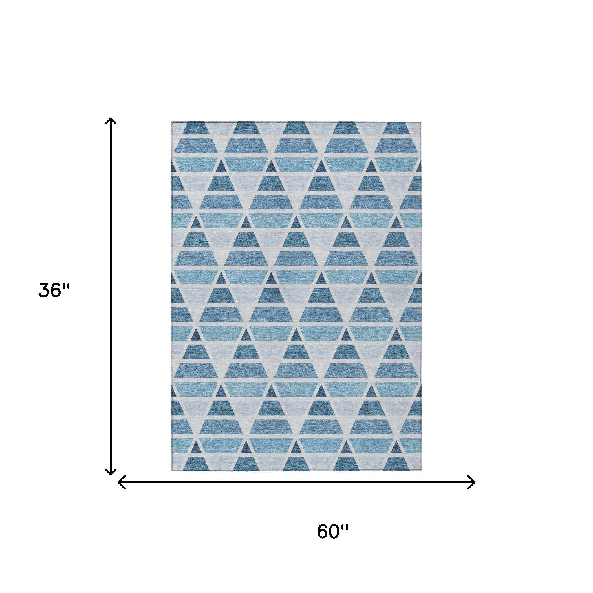 Blue and white geometric triangle area rug, 60" x 36", ideal for modern or coastal décor.