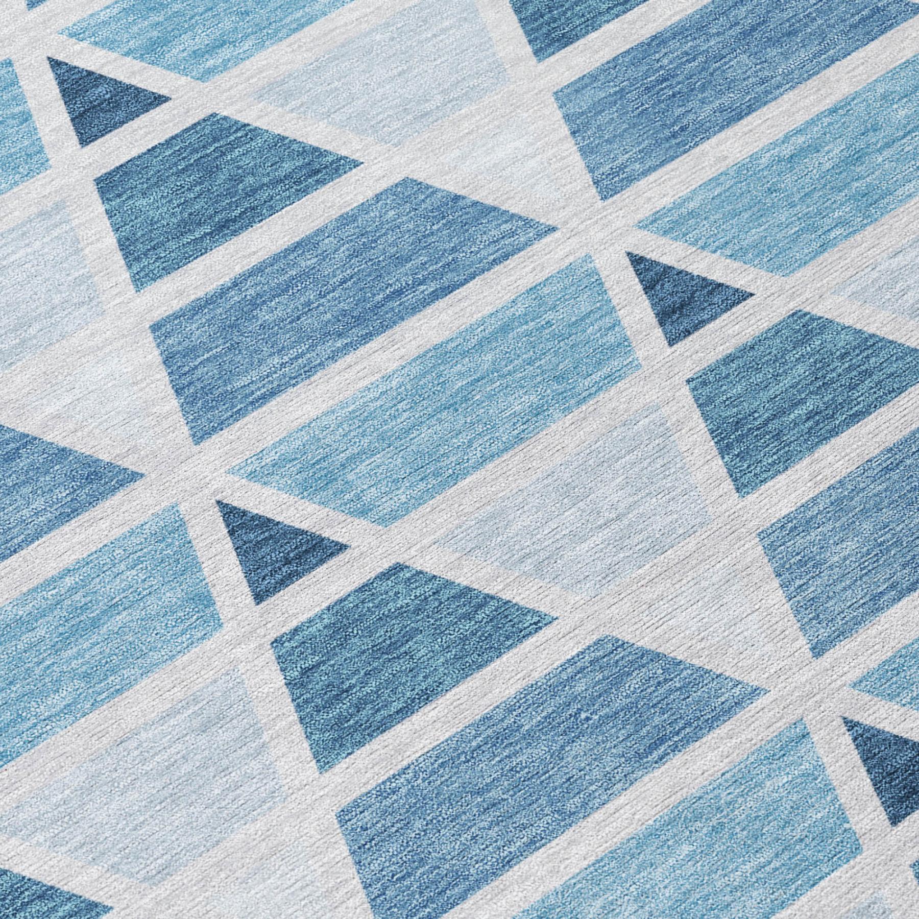 Blue geometric patterned area rug, featuring various shades of blue on a light background, perfect for modern decor.