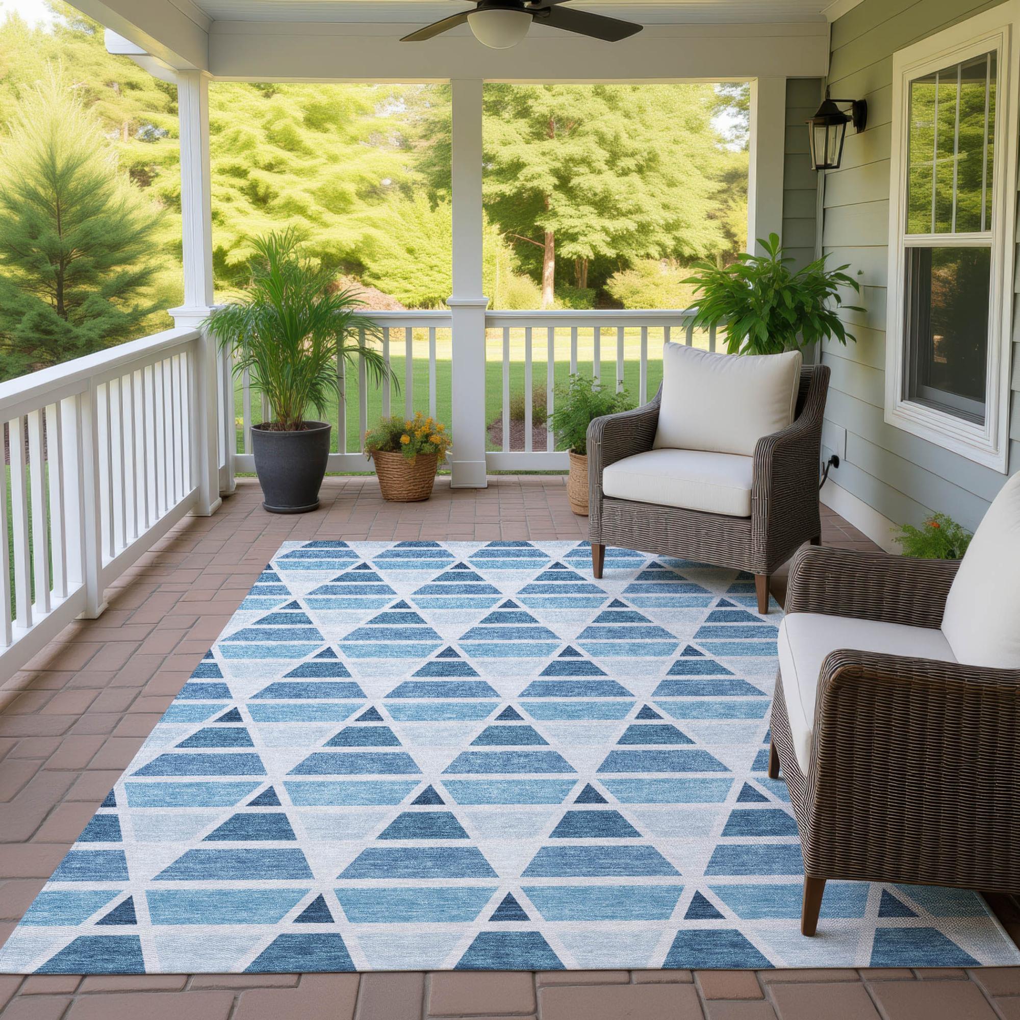 Blue and white geometric pattern area rug, ideal for outdoor patios, featuring triangle designs on a textured surface.