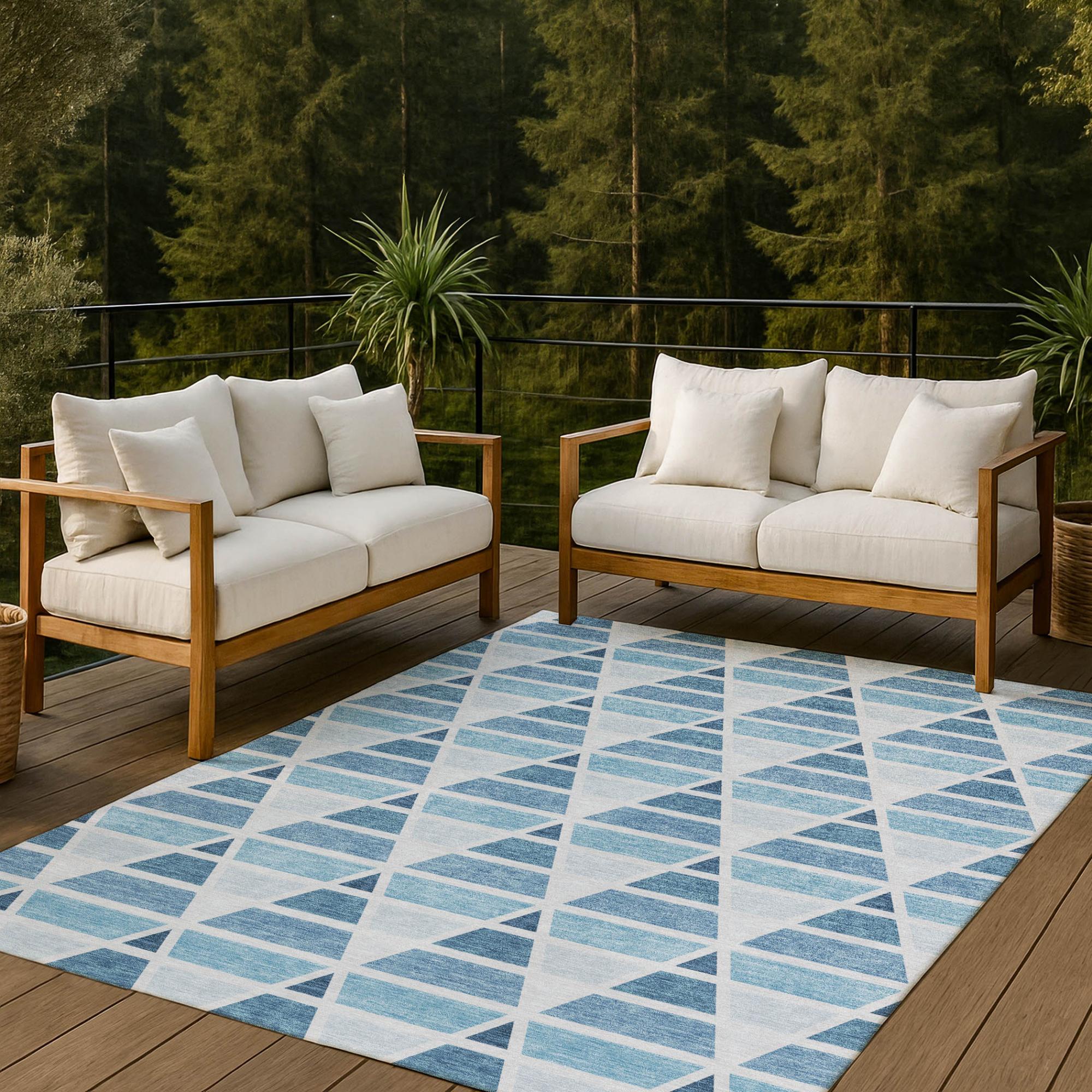 Indoor-outdoor geometric rug in blue and white, featuring modern triangle patterns, perfect for stylish patio or living space.
