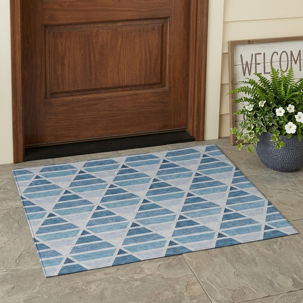Blue and gray geometric patterned indoor/outdoor rug, made of durable materials, perfect for doorways.