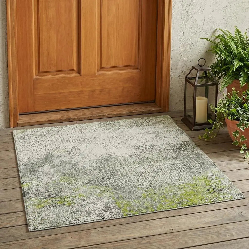 Gray and green abstract welcome mat on wooden porch, made of durable, weather-resistant material.