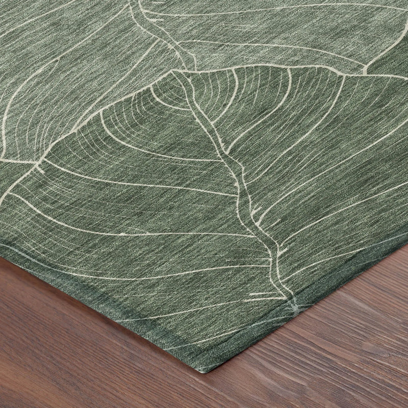 Green leaf-patterned area rug on a wooden floor, made from soft, durable fabric, ideal for modern interiors.