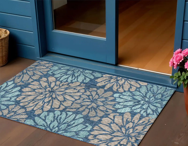 Blue floral patterned outdoor rug, made of durable material, perfect for entryways.