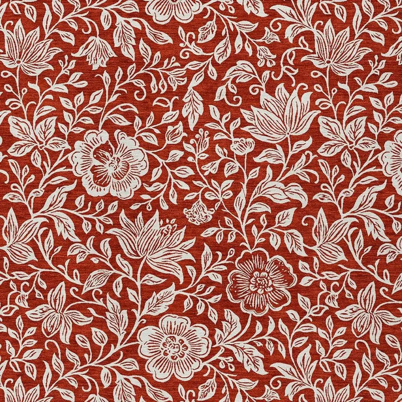 Red floral fabric with white botanical designs, perfect for home decor projects or clothing.