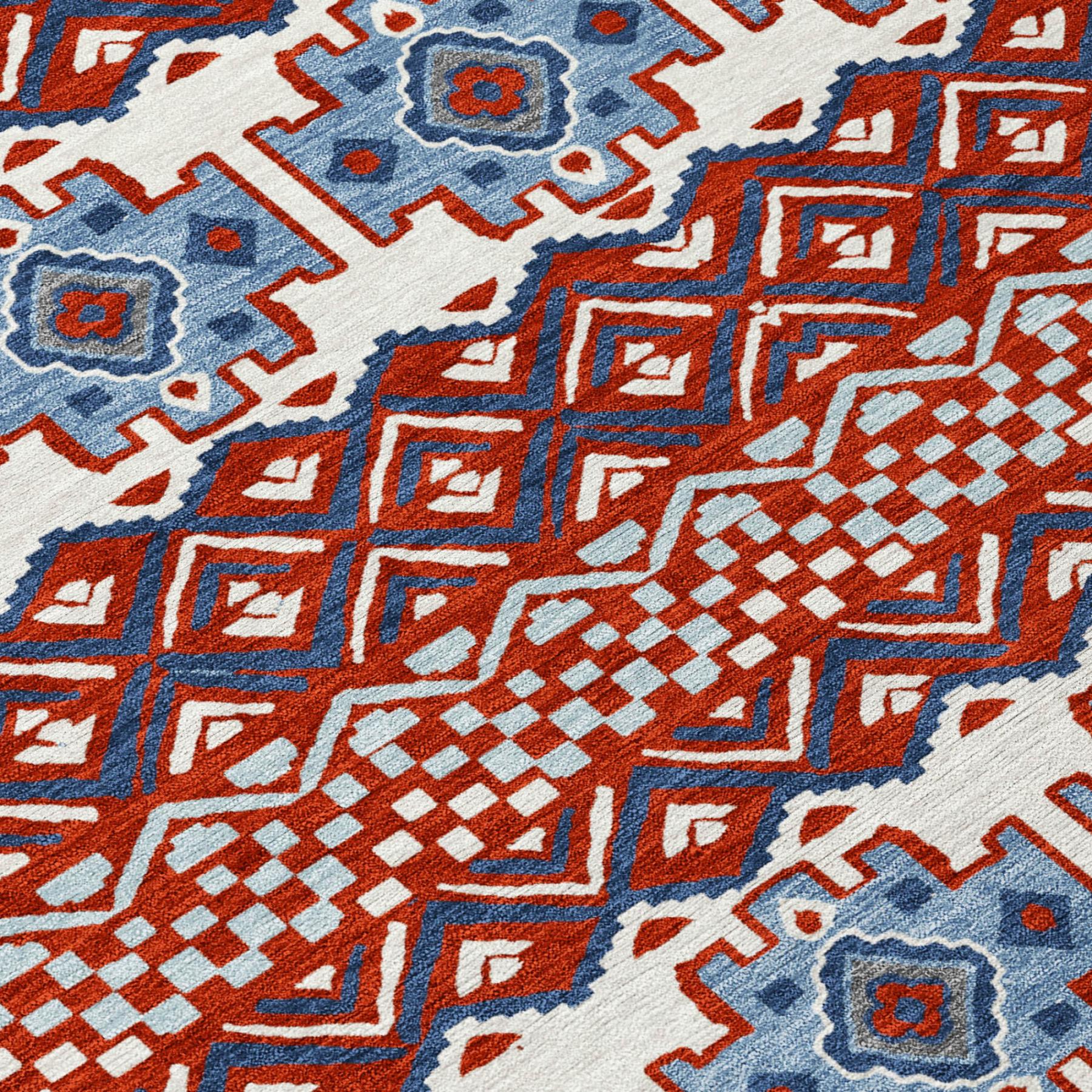 Colorful red, blue, and white patterned area rug, featuring geometric designs and a soft woven texture.