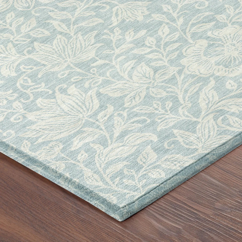 Light blue floral area rug with cream details, crafted from soft, durable fibers, perfect for modern home decor.