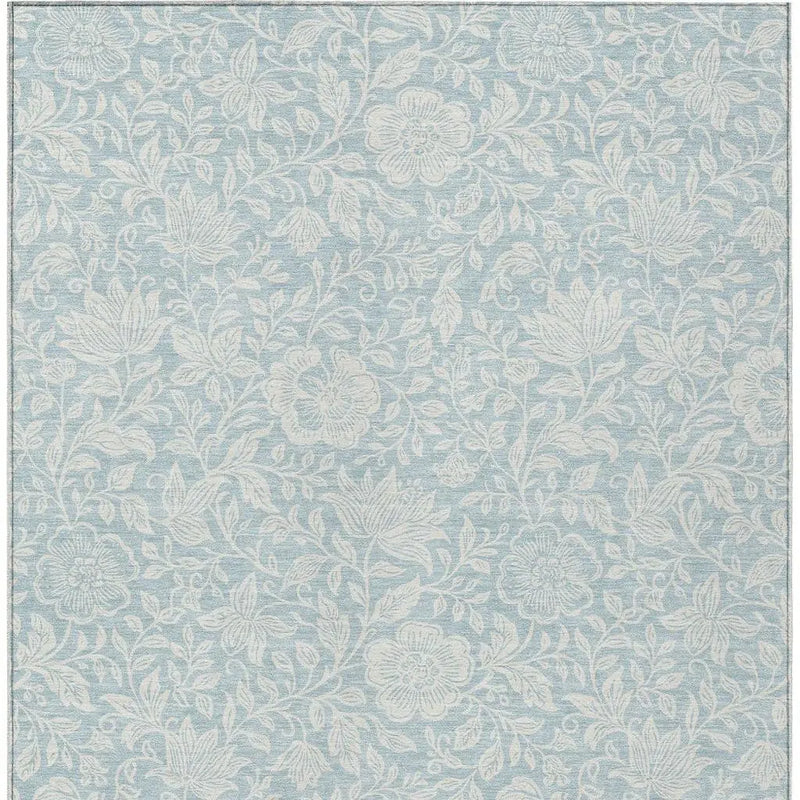 Light blue floral area rug with an intricate white pattern, made of durable, soft fibers for comfortable living spaces.