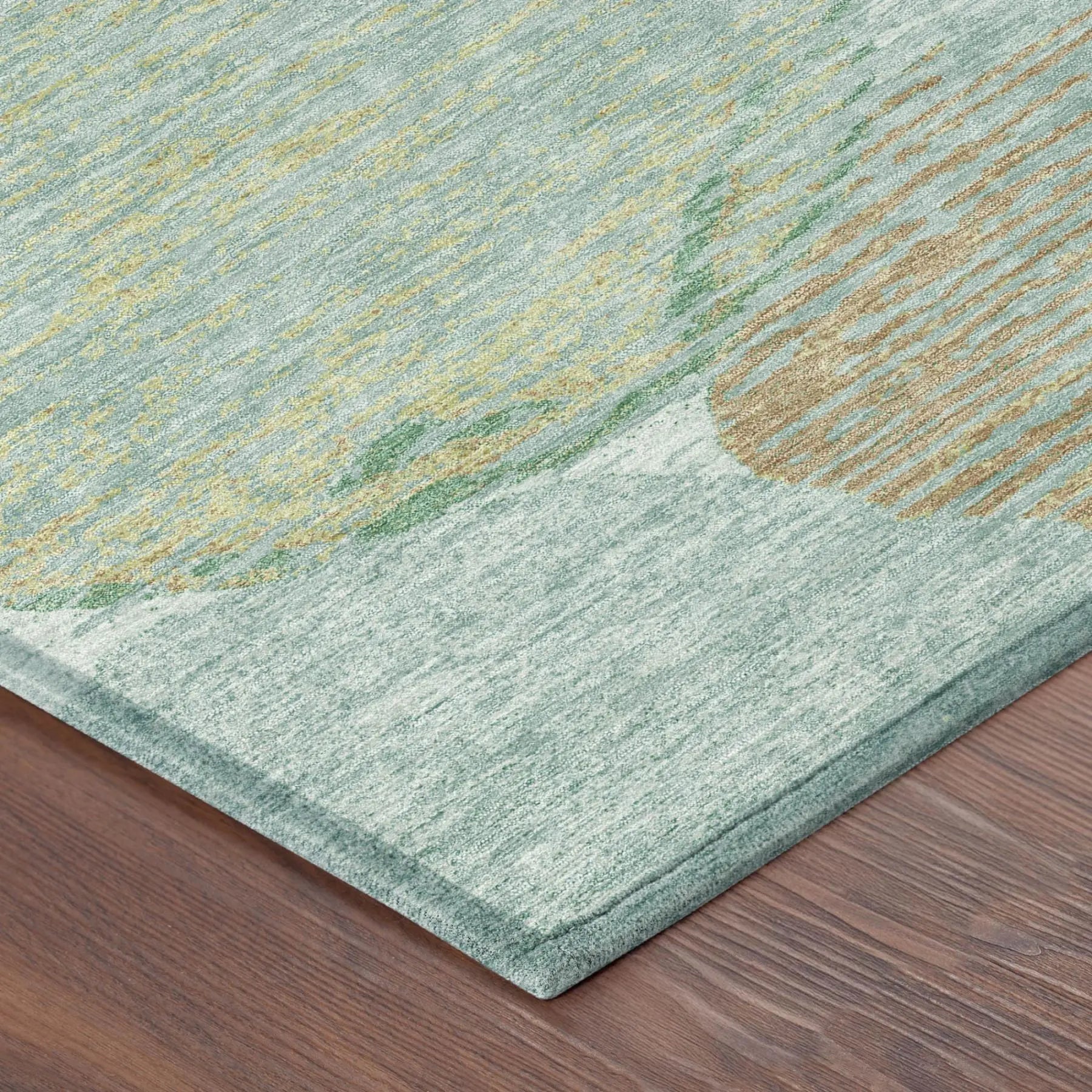 Light green abstract area rug with gold accents, made of soft, durable fibers, perfect for modern home decor.