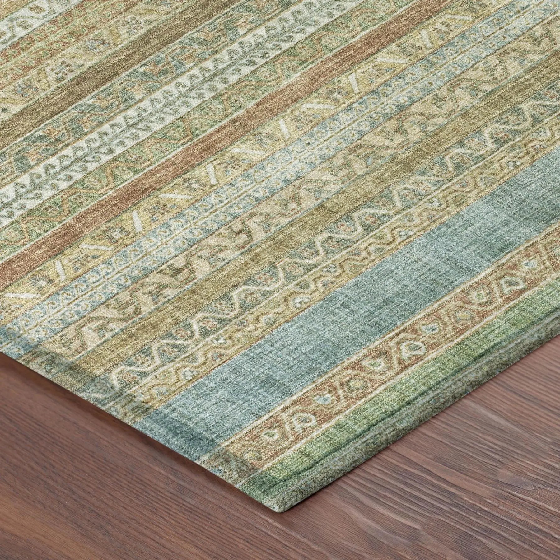 Multicolor area rug in green, beige, and rust featuring geometric patterns, perfect for modern or eclectic decor.