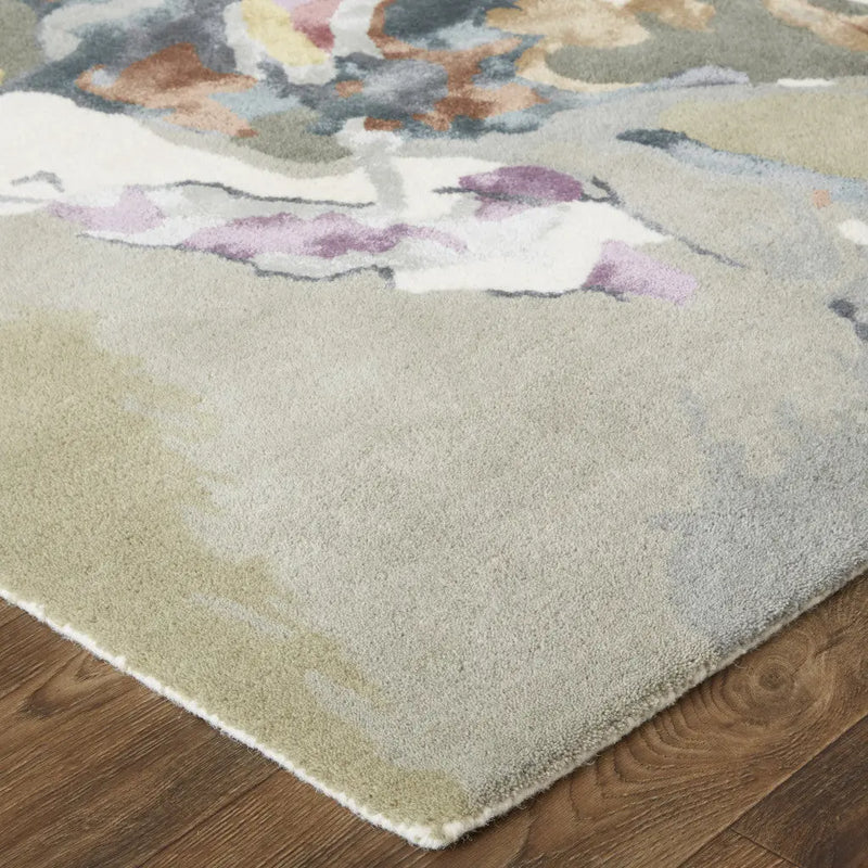 Soft beige area rug with watercolor abstract patterns in purple, blue, and gold, perfect for modern decor.
