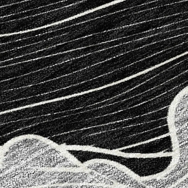 Black and white abstract area rug with wave pattern, crafted from soft synthetic fibers for modern decor.