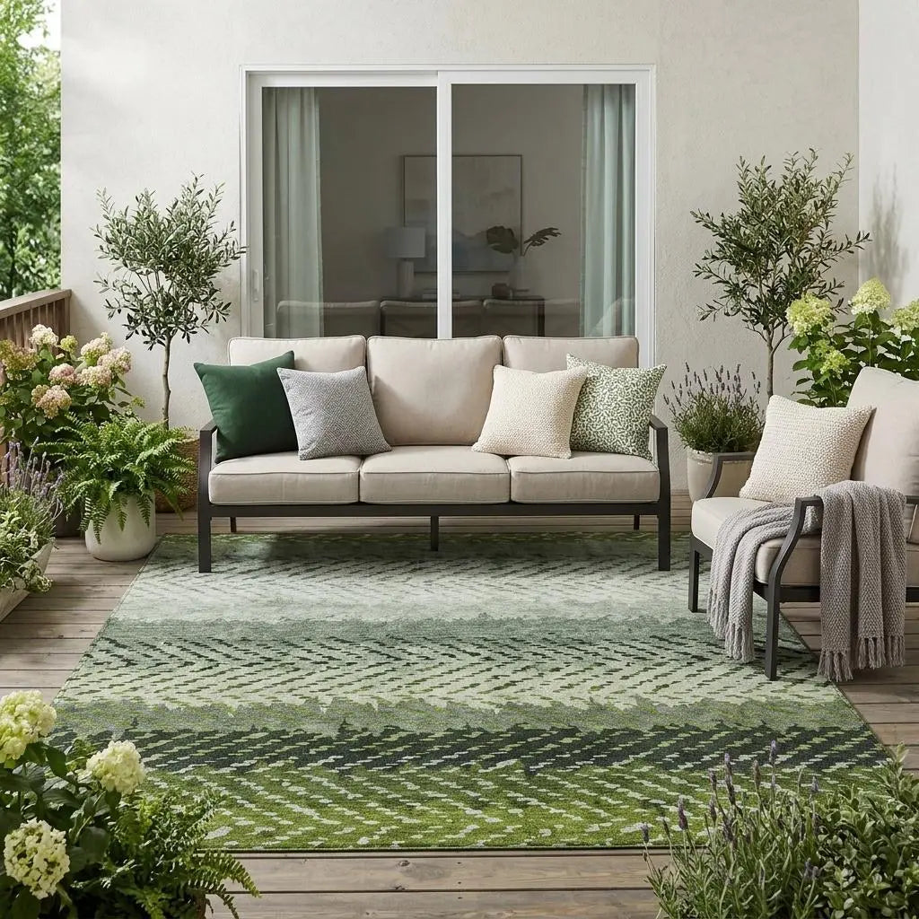 Green geometric outdoor rug, made of durable materials, enhancing a cozy patio setting with neutral furniture and greenery.