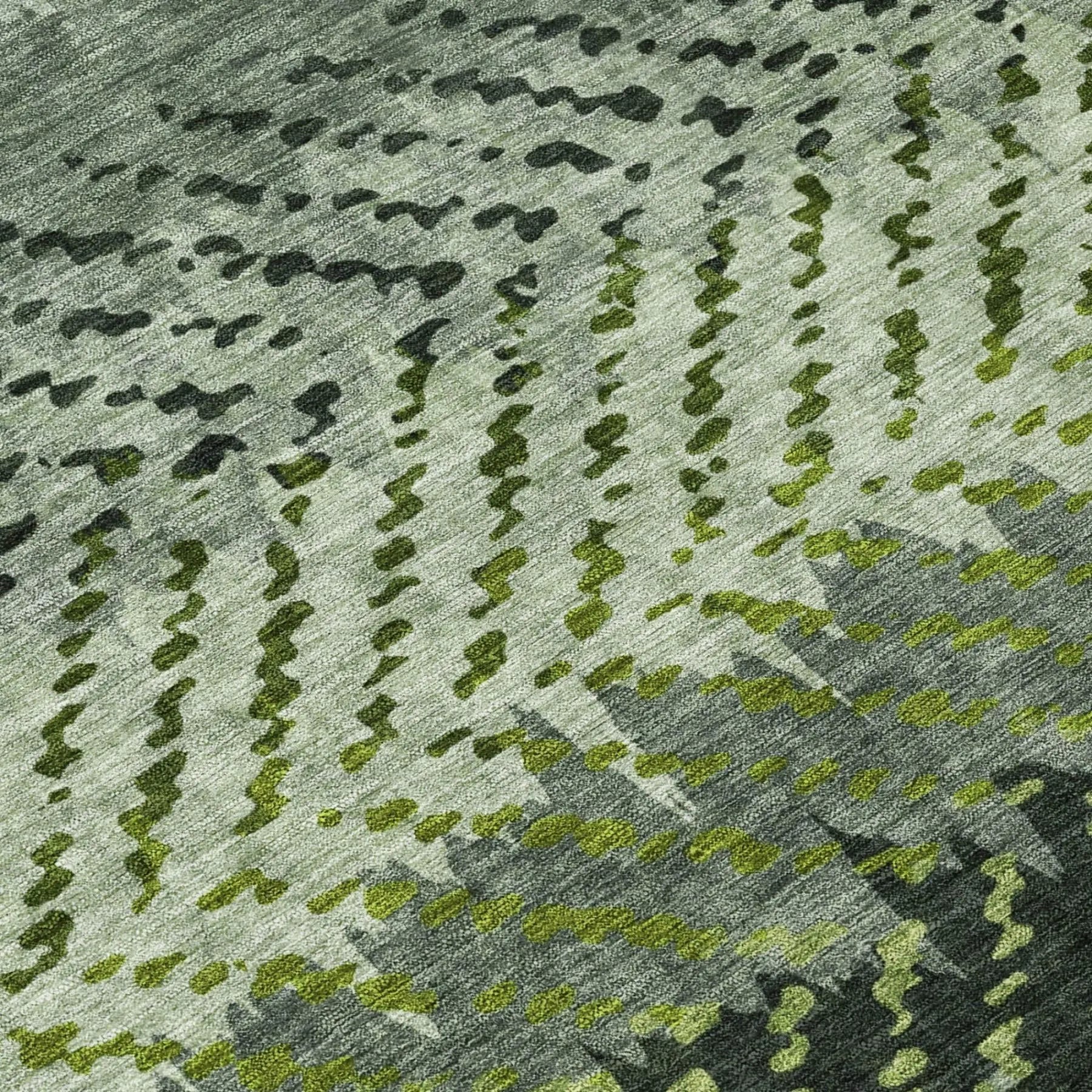 Textured green and gray area rug with abstract pattern, ideal for modern living spaces.