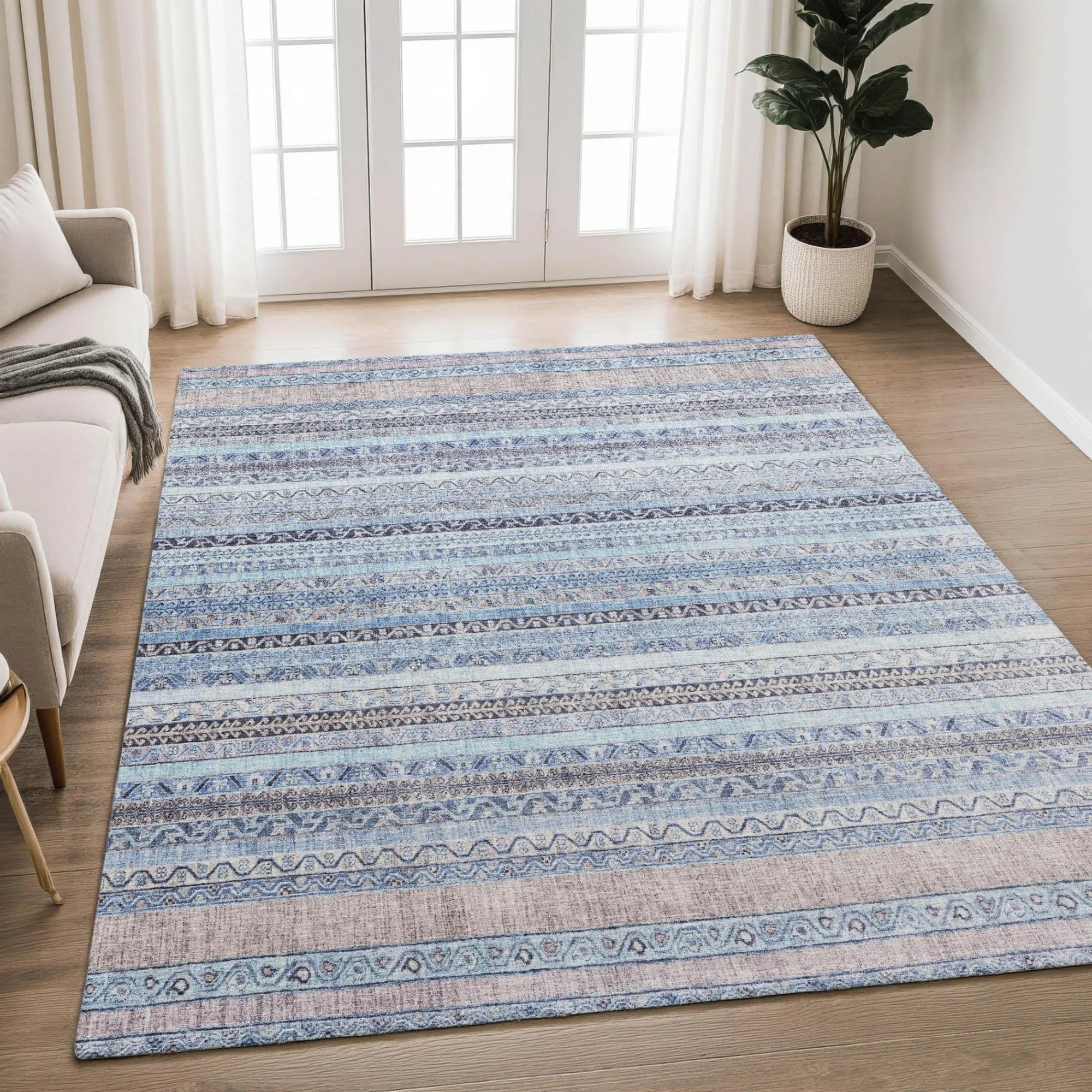 Blue striped area rug in soft, woven fabric, featuring intricate patterns for a modern living room decor.