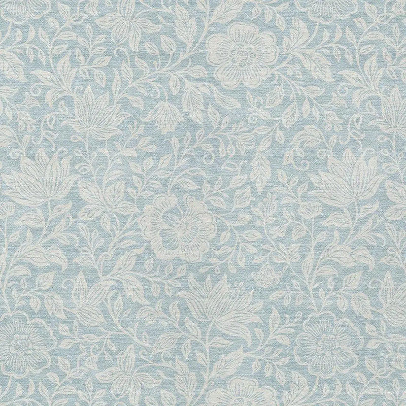 Light blue floral patterned fabric, featuring intricate white botanical designs, ideal for upholstery and home decor.