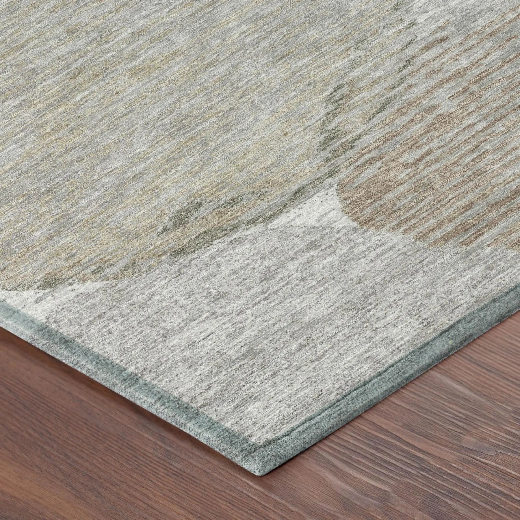 Light gray area rug with abstract design, soft synthetic material, and a subtle green border, perfect for modern decor.