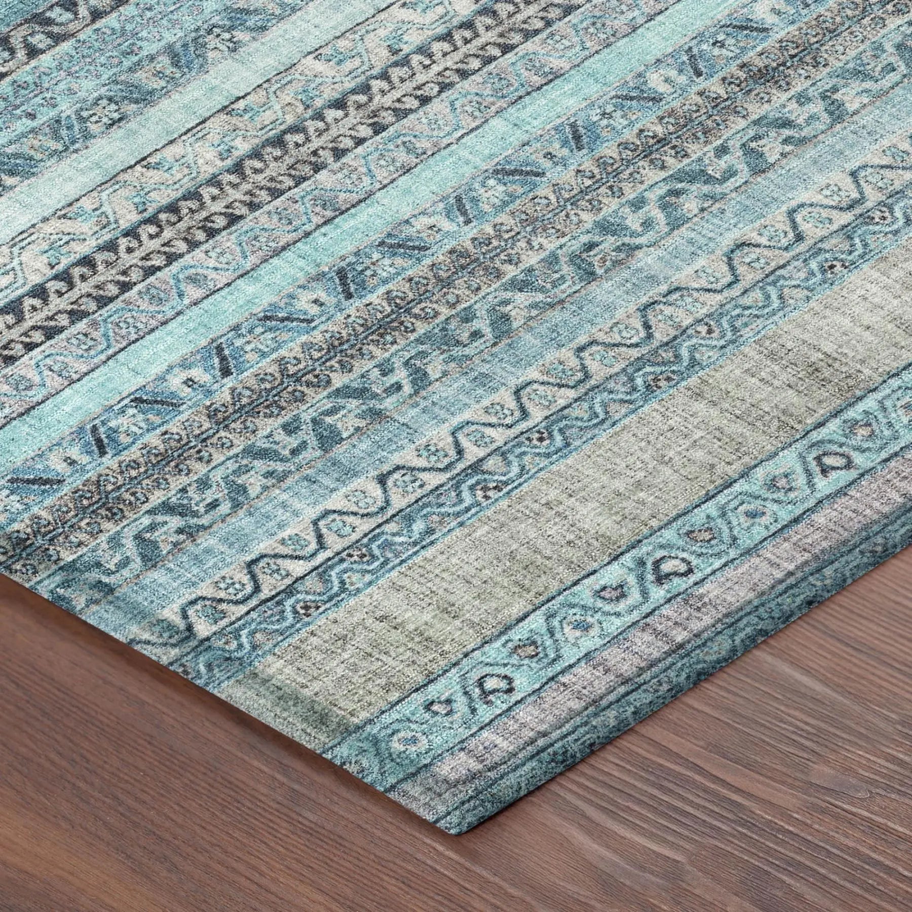 Turquoise patterned area rug with intricate designs and a soft texture, perfect for modern or bohemian decor.