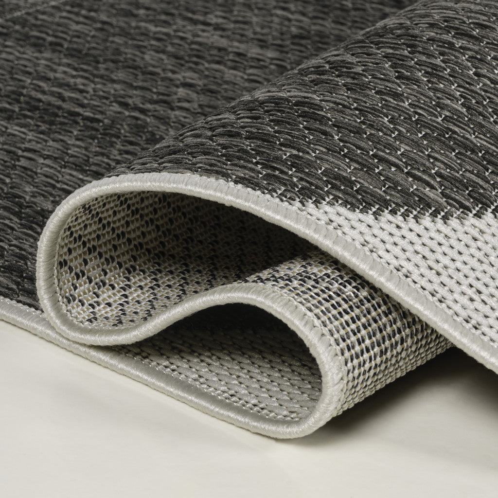 Gray and white woven area rug, featuring a textured pattern and durable material, perfect for modern home decor.