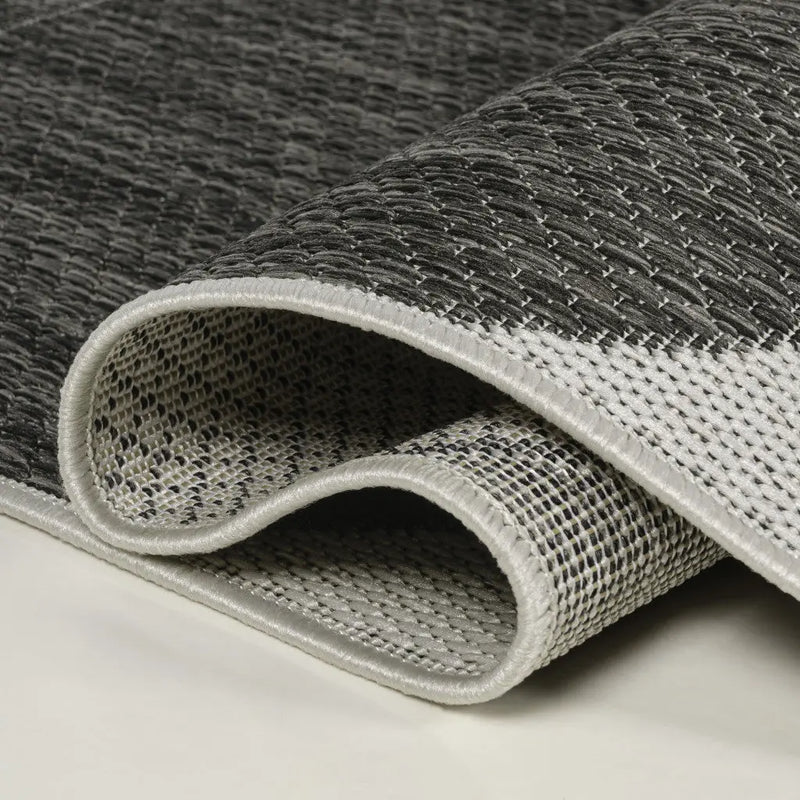 Gray and white woven area rug, featuring a textured pattern and durable material, perfect for modern home decor.