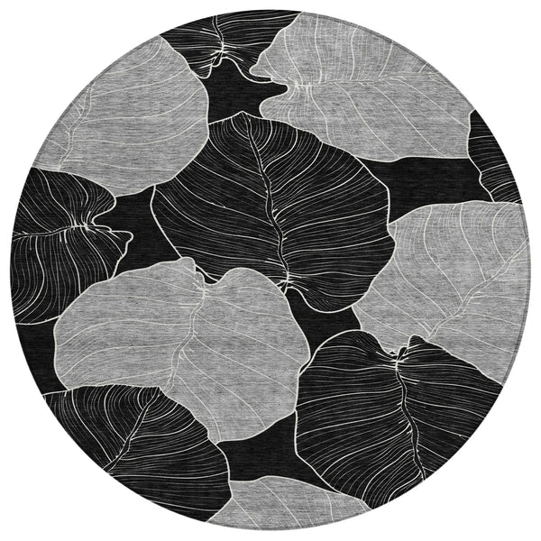 Black and white leaf-patterned round rug, made of durable material, perfect for modern home decor.