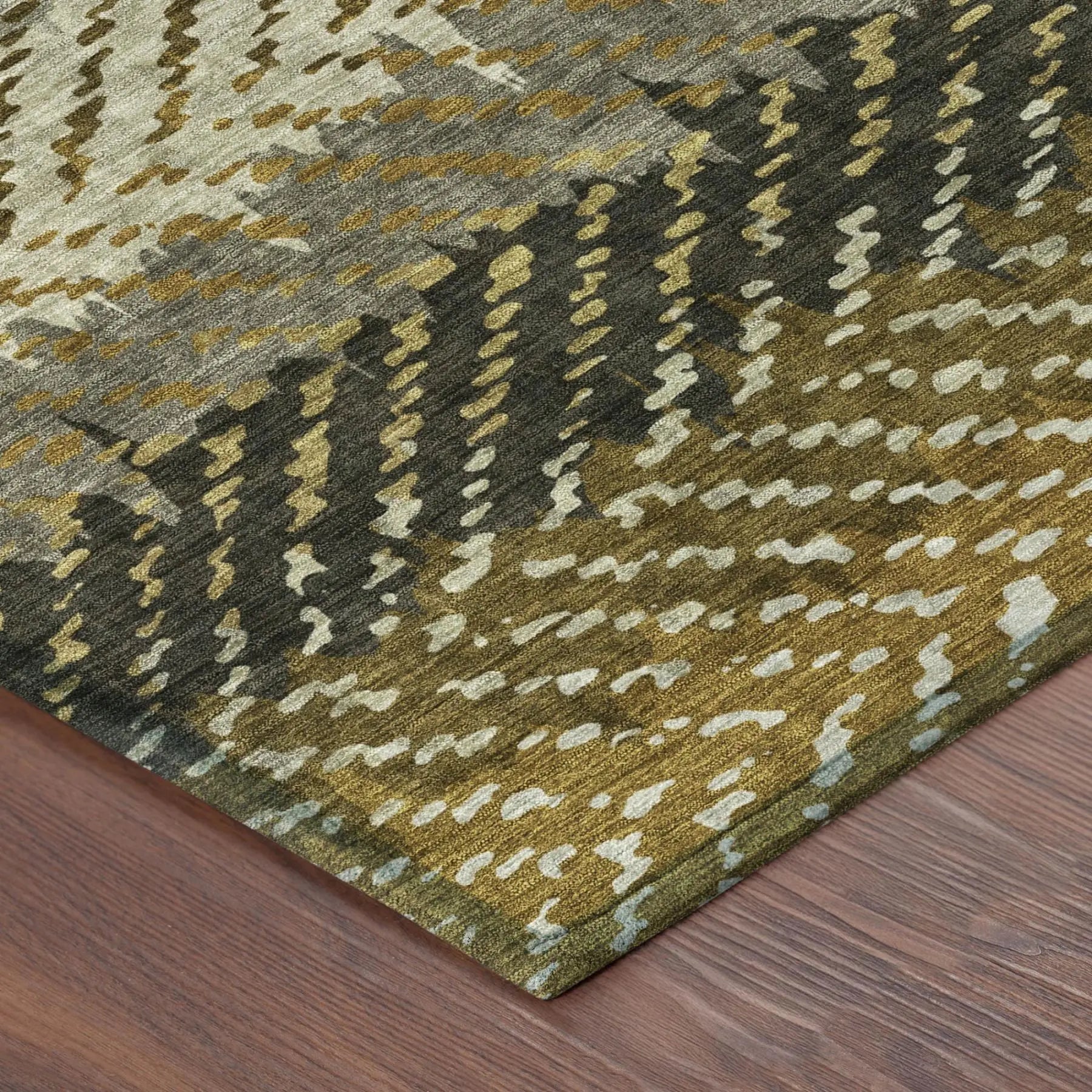 Abstract gold and gray patterned area rug in soft, plush material, perfect for modern home decor.