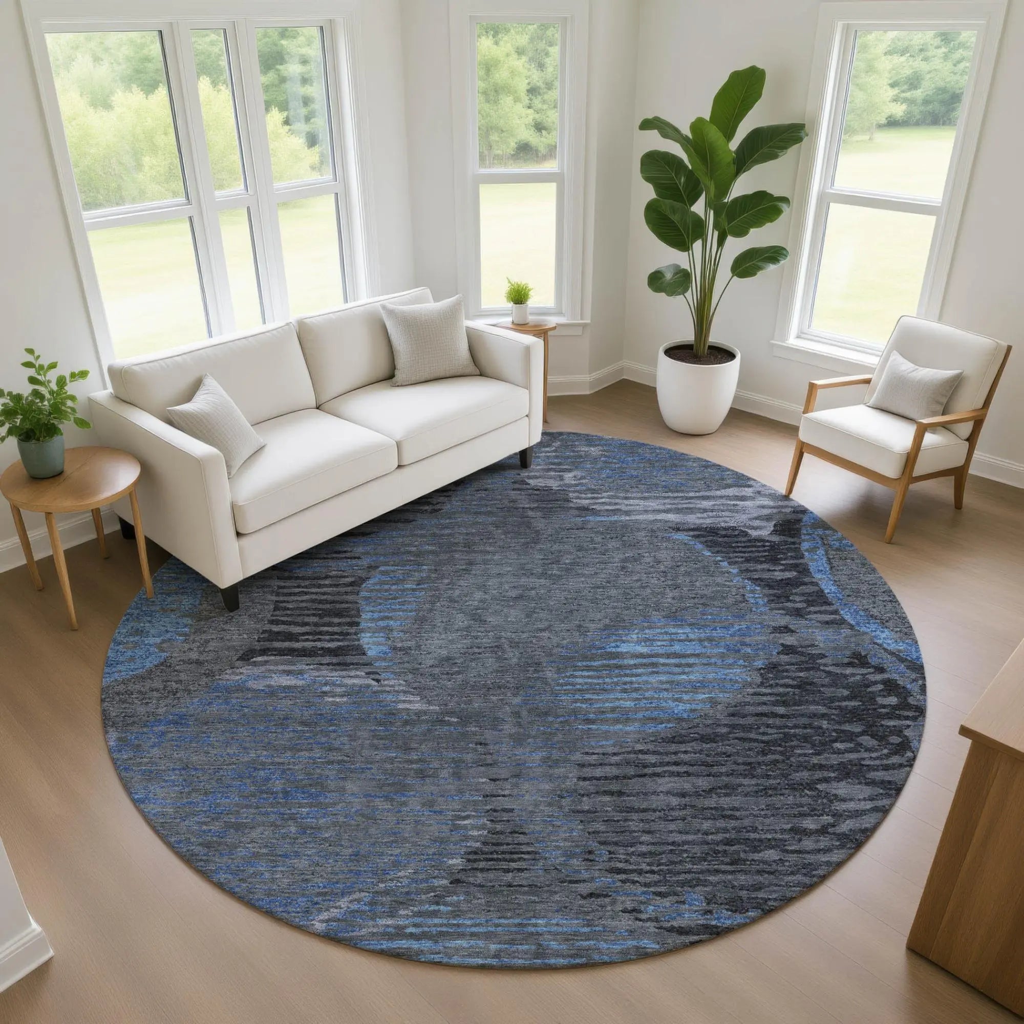 Round area rug in shades of blue and gray, featuring a modern abstract design, perfect for contemporary living spaces.