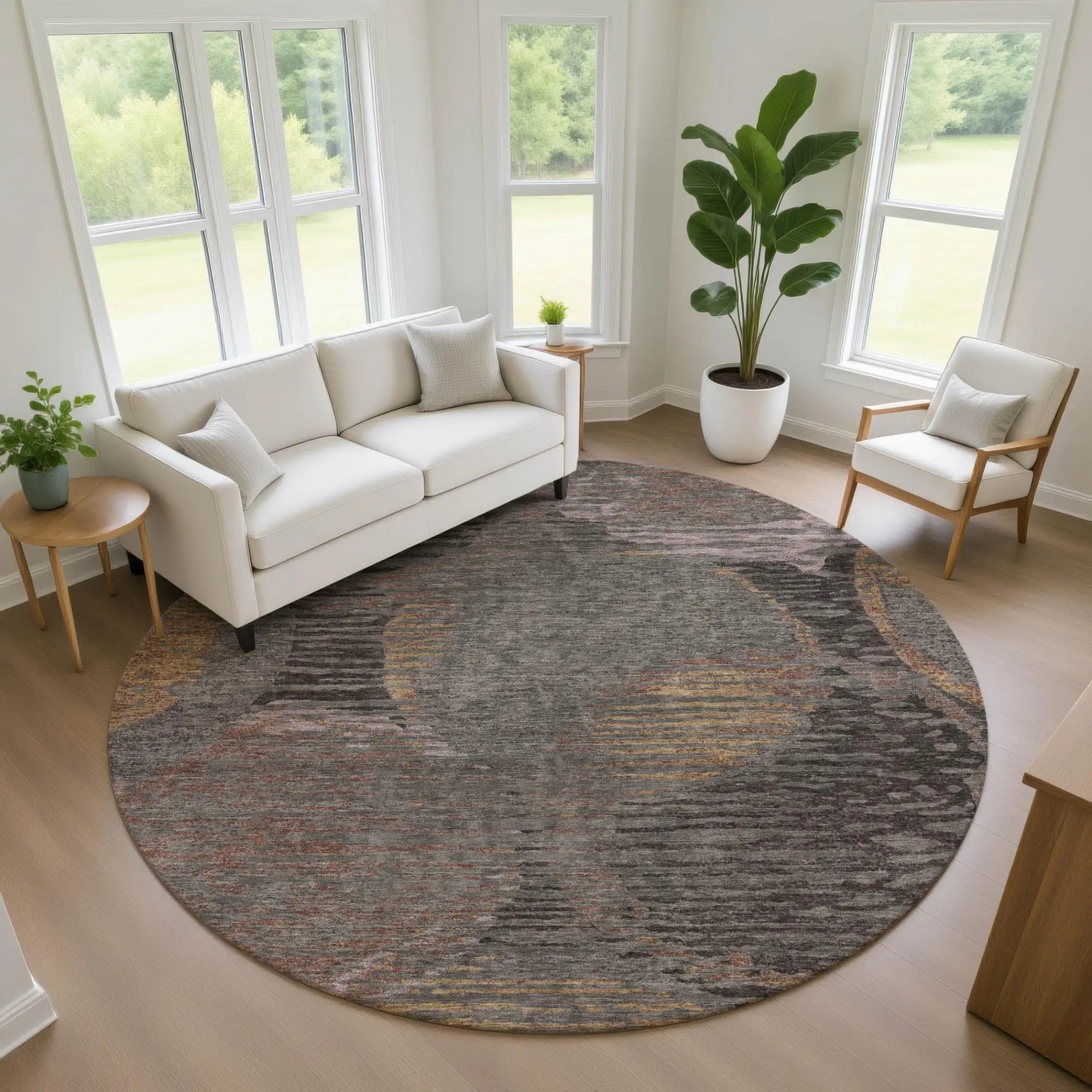 Round gray area rug with abstract patterns in orange and yellow, perfect for modern living room decor.