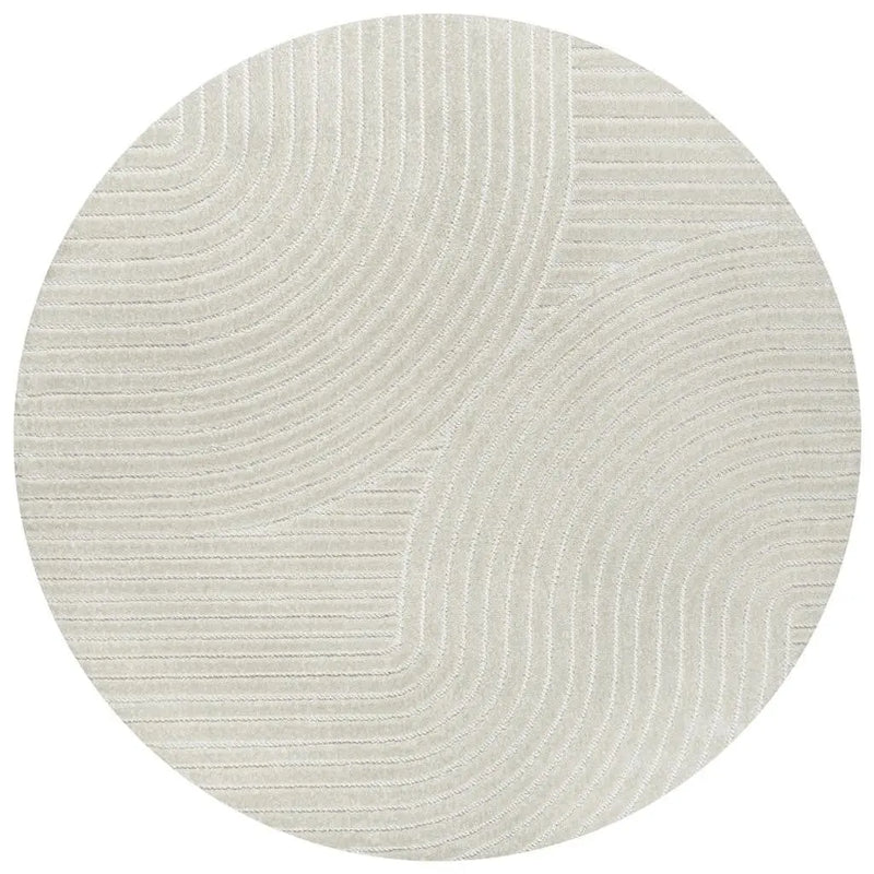 Round beige area rug with textured linear patterns, made of soft synthetic fibers for modern home decor.