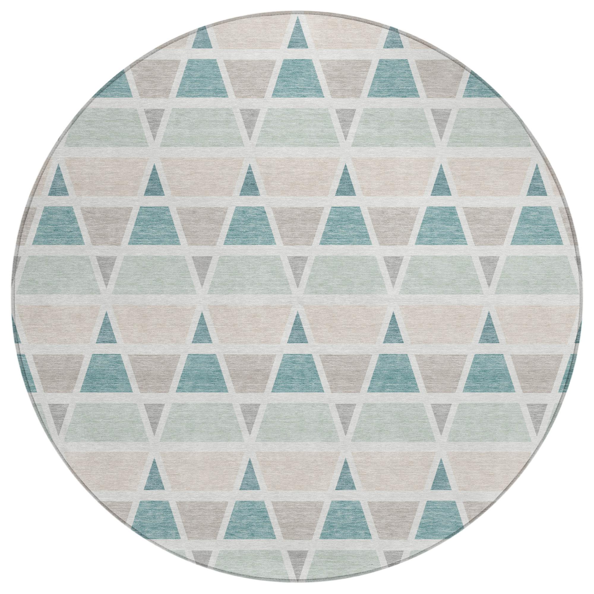 Round area rug featuring a geometric triangle pattern in teal, mint green, and beige, made of soft, durable fiber.