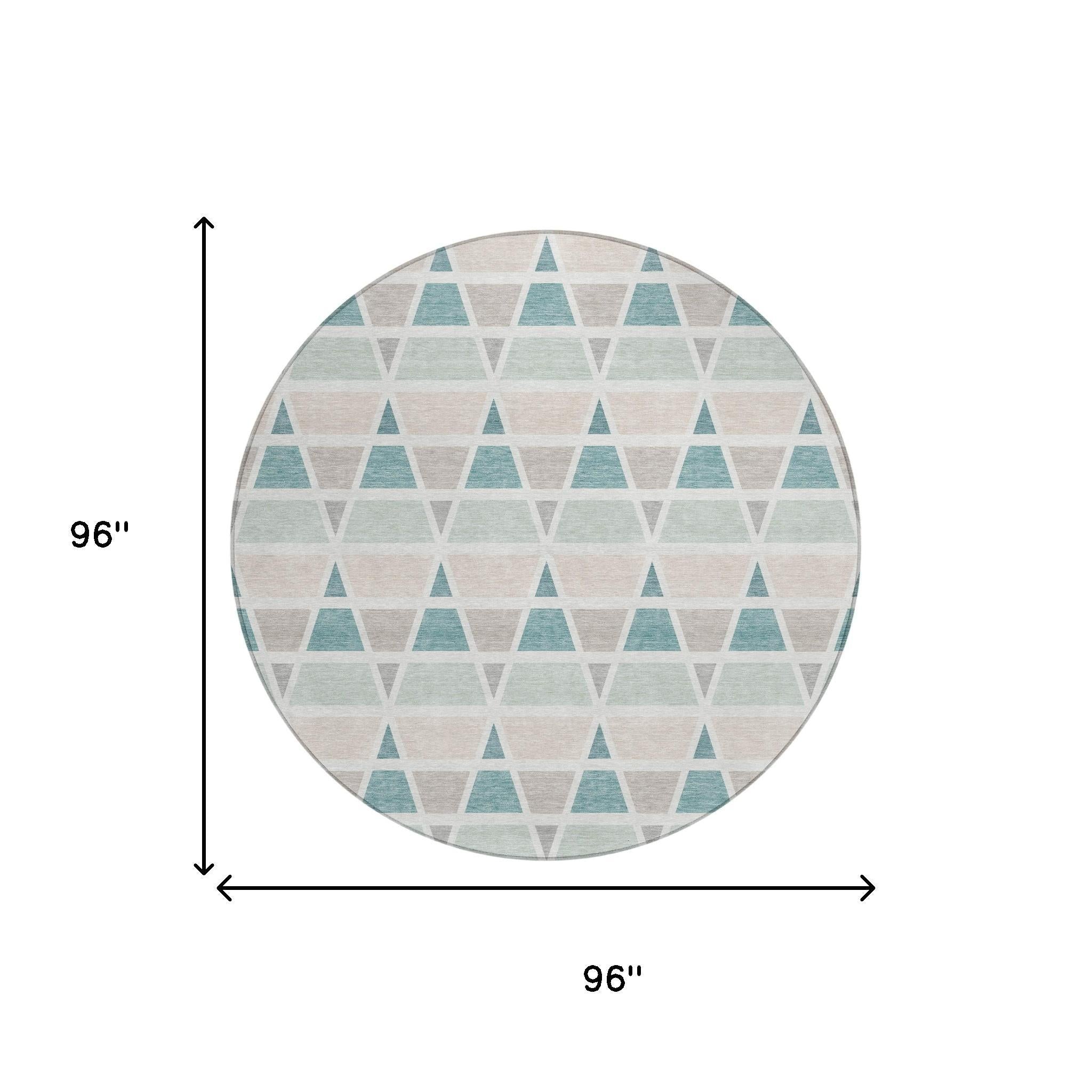 Round 96" area rug featuring a geometric triangle pattern in shades of teal, soft beige, and light gray, made of durable material.