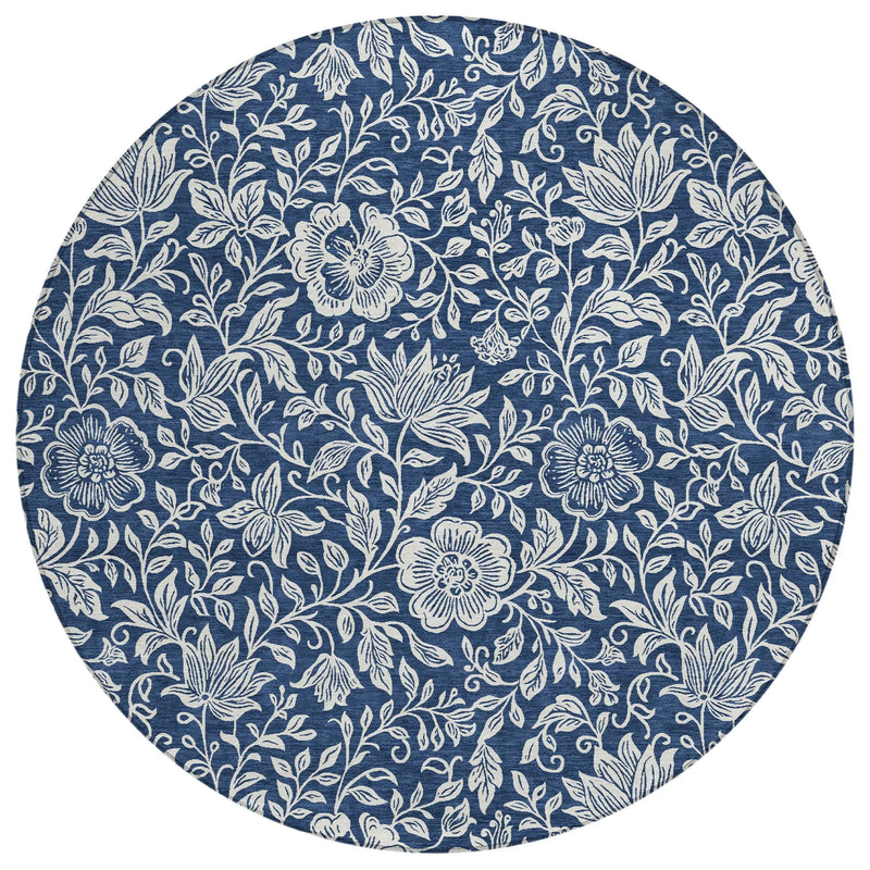 Round blue floral tablecloth featuring intricate white flower patterns in a classic vintage style.