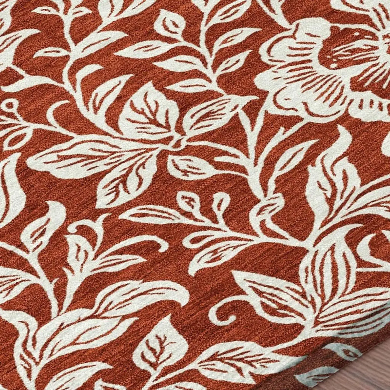 Rustic orange area rug with white floral design, soft texture, perfect for cozy home decor.